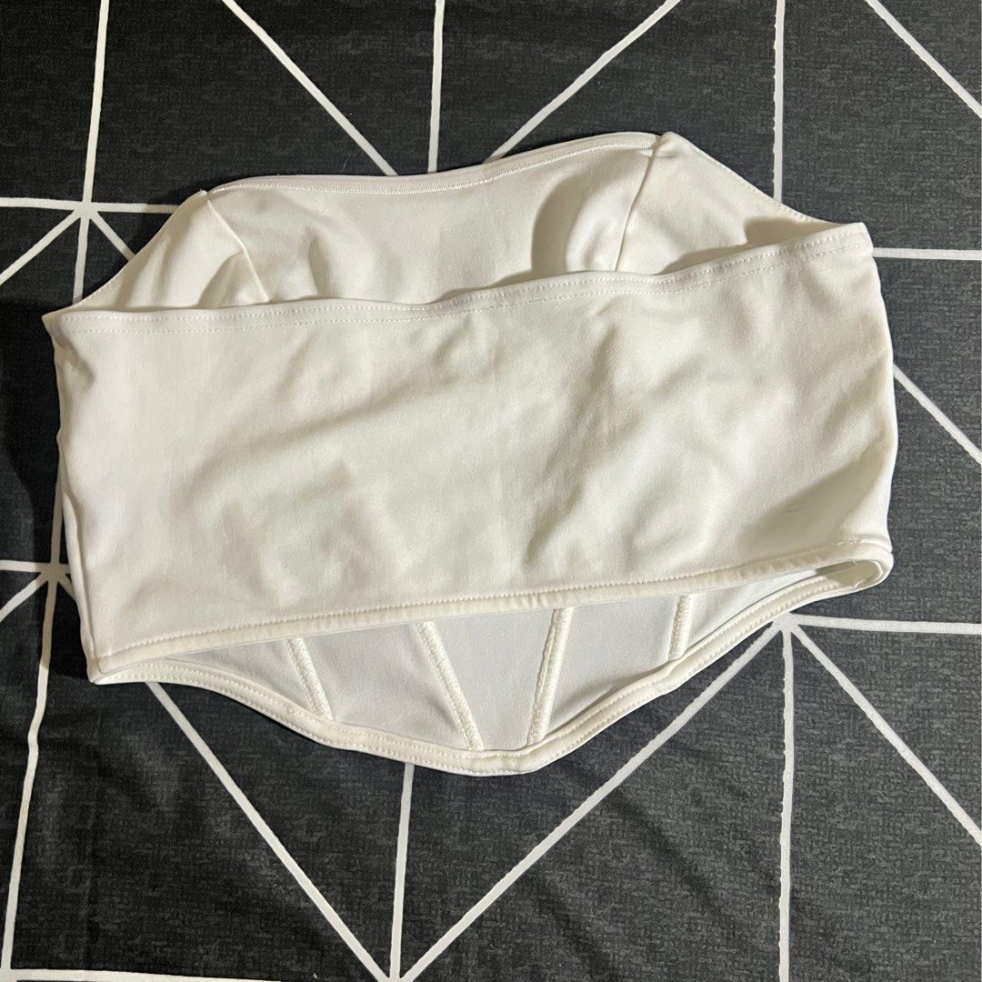 White Corset Tube Top (Category: Others Tops) located in Marikina City. Submitted by preloved.mana (Listing ID 1460777008, Image 2). Description: - White corset top - boning at bottom design - Medium MOP: gcash, maya MOD: jnt, lalamove LOC: marikina .