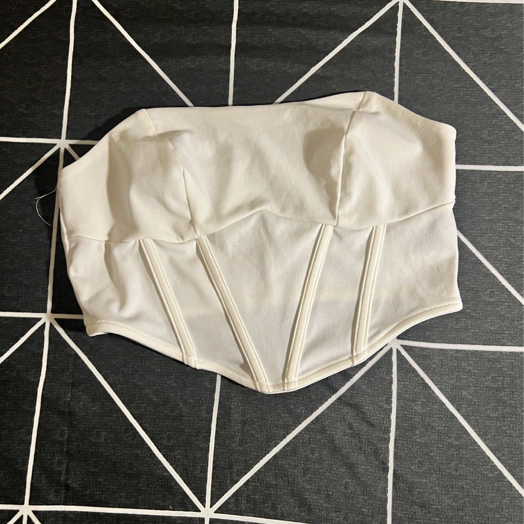 White Corset Tube Top (Category: Others Tops) located in Marikina City. Submitted by preloved.mana (Listing ID 1460777008, Image 1). Description: - White corset top - boning at bottom design - Medium MOP: gcash, maya MOD: jnt, lalamove LOC: marikina .