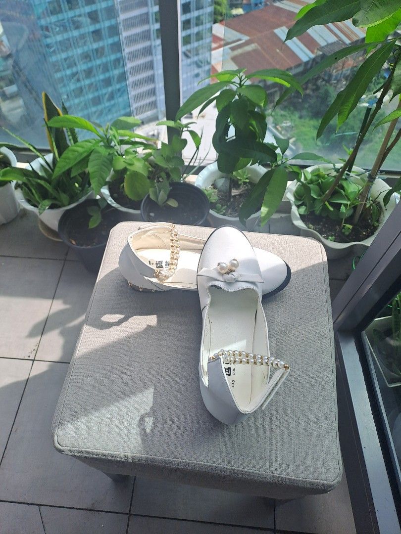 White Mary Jane shoes (Category: Sandals) located in Manila. Submitted by joanbalde39643 (Listing ID 1460732220, Image 1). Description: These are elegant white Mary Jane princess dress shoes tailored for young girls. They are characterized by a classic rounded closed toe, a delicate white bow on the front vamp accented with hanging faux pearls, and a distinctive high ankle cuff wrapped with strands of faux pearl beads. best fit to 36.5 or 7 slim 