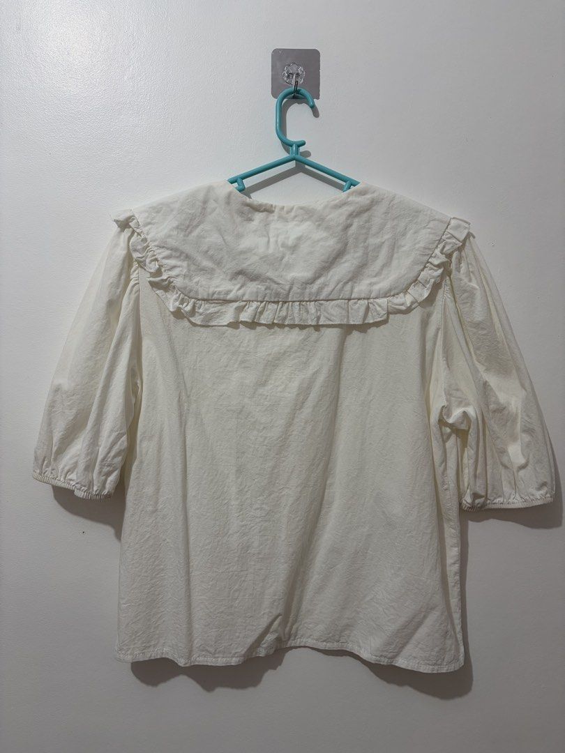 Off White Peter Pan Collar Coquette Blouse with Ruffle Trim (Category: Blouses) located in Naga. Submitted by pompompurinlover (Listing ID 1460839367, Image 2). Description: - Best fits s-m - Nice for layering - Flaw: missing 3rd button - Cute white blouse - Large ruffled Peter Pan collar - Button-up front - Puff sleeves with elastic cuffs - Easy to style for a sweet, vintage-inspired look - Comfortable fabric (cotton/linen) tags: coquette y2k wh