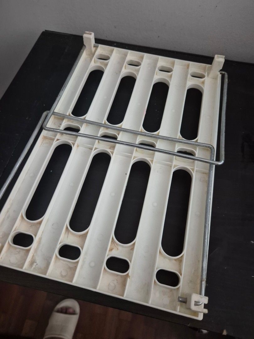 White Plastic Storage Shelf with Metal Rods (Category: Shelves, Cabinets & Racks) located in Manila. Submitted by zotag (Listing ID 1460717565, Image 3). Description: - White plastic shelf with sturdy metal support rods. - Features a slatted design for excellent ventilation. - Ideal for general storage and organizing needs. - Can also serve as a base for other items. - Shows minor signs of use, but remains fully functional..