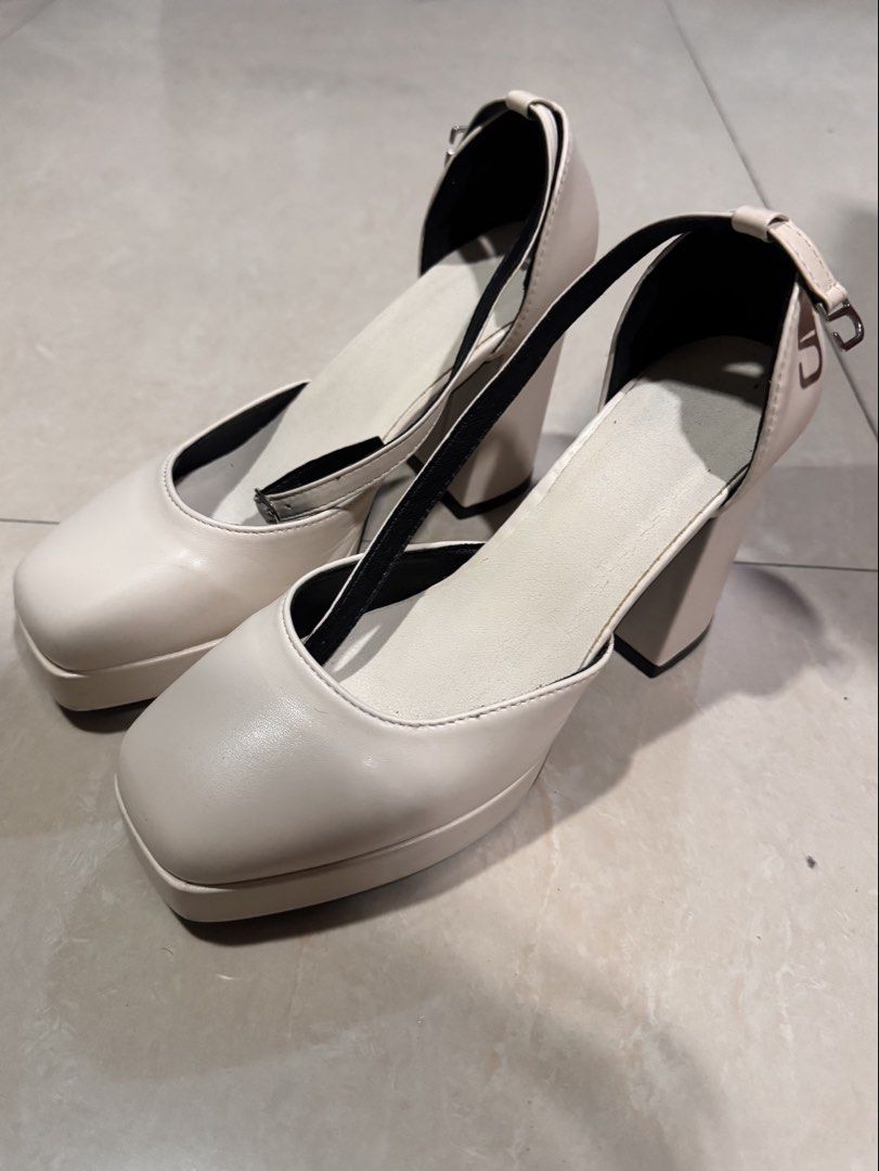 White Platform Chunky Heel Ankle Strap Heels (Category: Heels) located in Taguig. Submitted by stuffsforlife101 (Listing ID 1460861396, Image 2). Description: - White platform heels - Chunky block heel for stability and comfort - Adjustable ankle strap with buckle closure - Stylish square toe design - Versatile for dressing up outfits - Comfortable for extended wear.