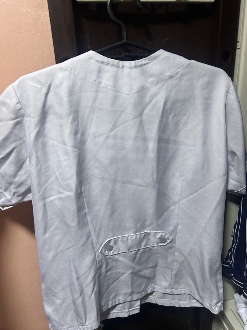 White Uniform Top with Pockets (Category: Others Tops) located in Caloocan City. Submitted by sunkissedt (Listing ID 1460912511, Image 2). Description: - Classic white short-sleeved uniform top - 4 available (200ea; take all for 700php) - 21.5 in x 17 in - Functional front button closure - Convenient pocket placement: two on the bottom, one on the chest - Ideal for healthcare professionals and various work settings - used only for a year in schoo