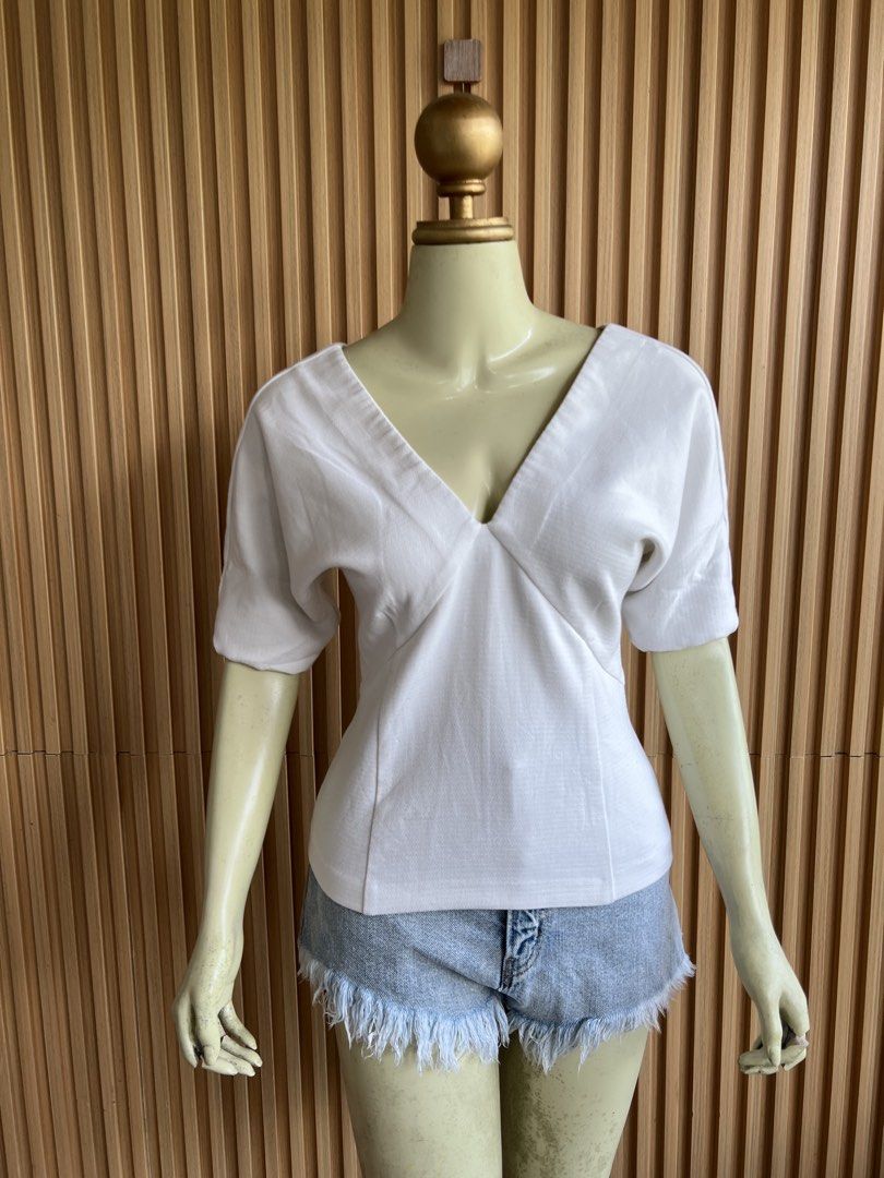 White V-Neck Dolman Sleeve Top (Category: Blouses) located in Lipa City. Submitted by thyra06 (Listing ID 1460752526, Image 3). Description: - White cropped top - Deep V-neckline - Dolman sleeves - Textured fabric - Versatile: dress up or down - Pairs well with shorts or skirts - Simple and chic design.
