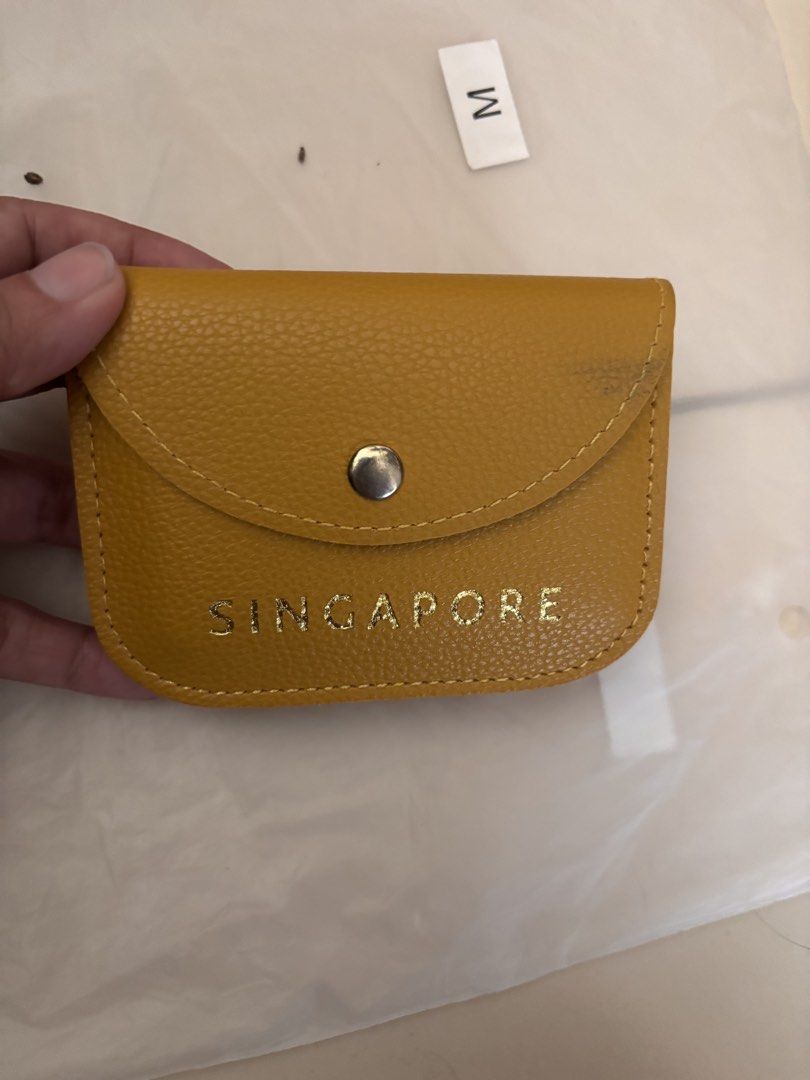 Yellow Singapore Card Holder (Category: Wallets & Card holders) located in Pasig City. Submitted by bookishnook (Listing ID 1460772146, Image 1). Description: - Cute yellow card holder - 'SINGAPORE' printed in gold - Secure snap button closure - Ample space for multiple cards - Small and compact design - Ideal for keeping essential cards organized.