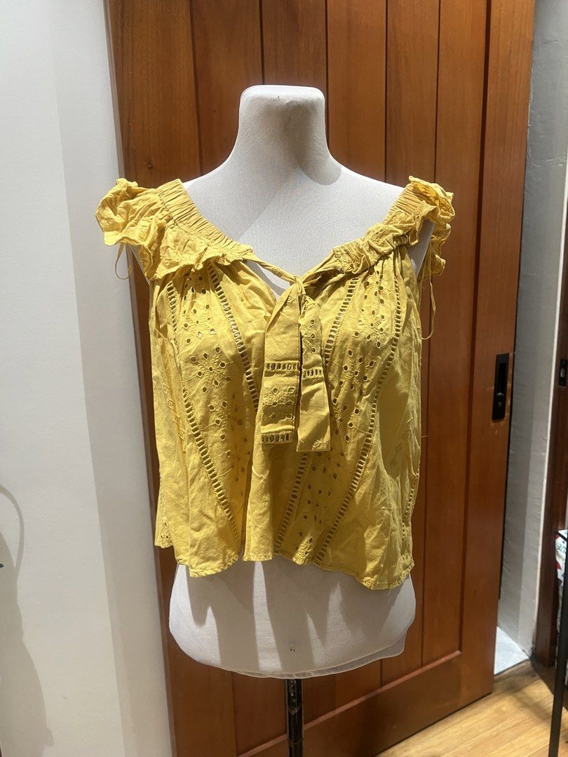 Zara TRF Yellow Eyelet Off-Shoulder Top (Category: Blouses) located in Quezon City. Submitted by iminquezoncity (Listing ID 1460809525, Image 1). Description: - Zara TRF yellow off-shoulder top - Eyelet details and tie-front neckline - Ruffled trim along neckline and sleeves - Lightweight and airy fabric - Ideal for warm weather - Versatile styling with shorts or jeans.