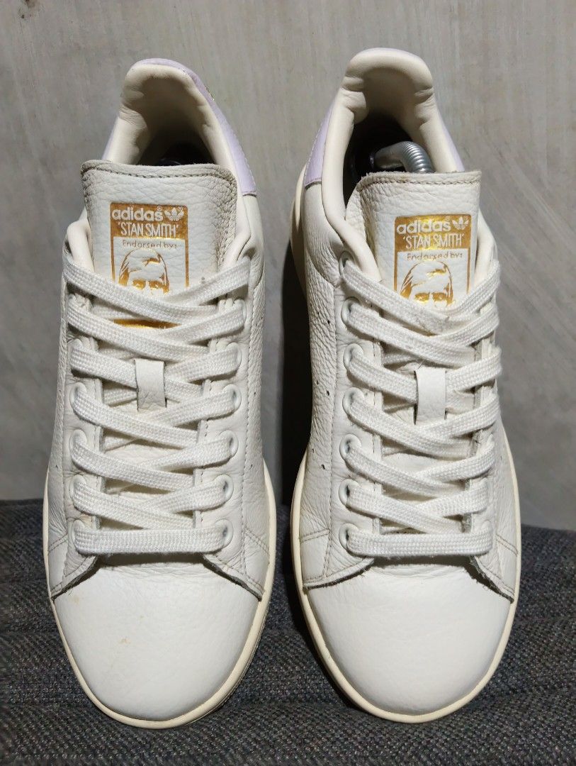 7 Women Adidas Stan Smith (Category: Sneakers) located in Cavite. Submitted by ronessabrandedshoes2ndaccount (Listing ID 1460989061, Image 2). Description: - Adidas Stan Smith sneakers - Limited Design - Color: Cream leather with lavender accents on the heel - Details: Gold embroidery for 'Stan' and 'Smith', classic perforated stripes - Ideal for: Casual wear.