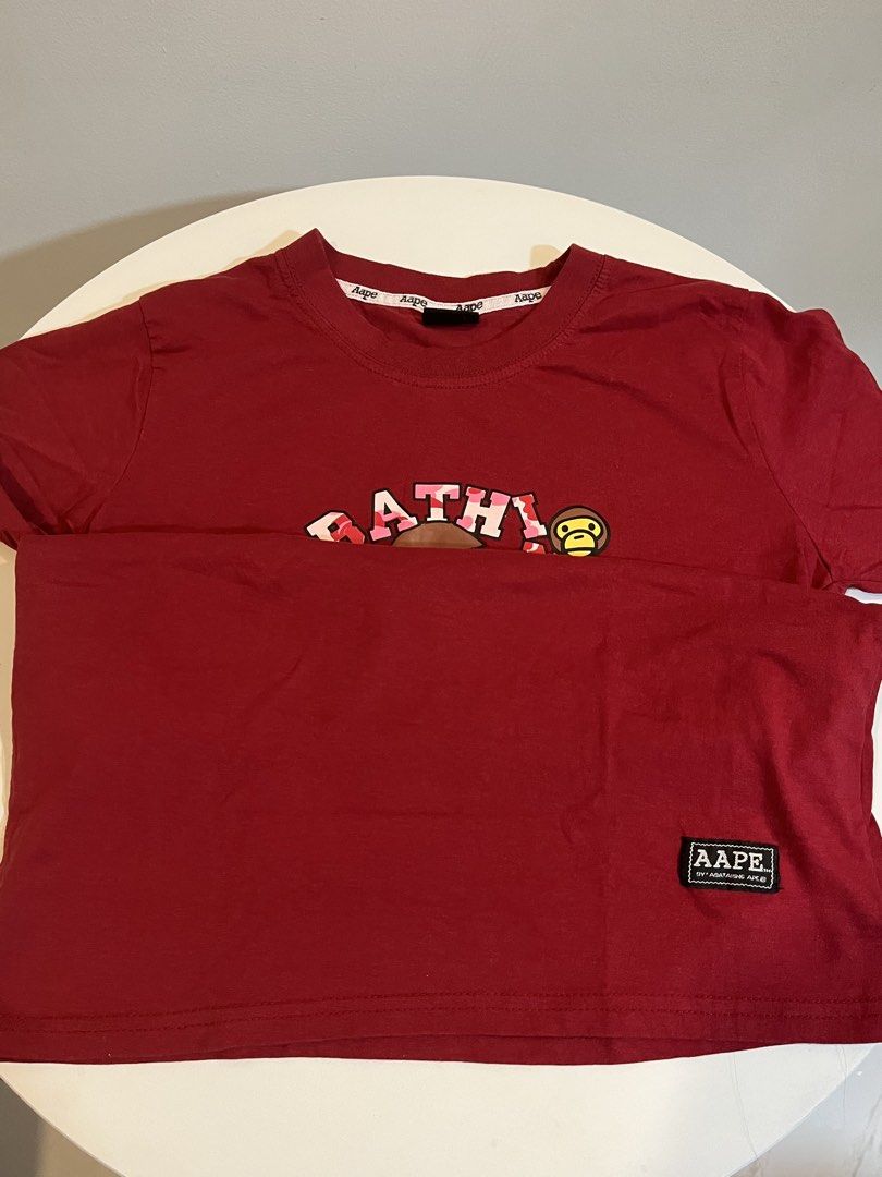 Aape by A Bathing Ape Red Monkey Print T-shirt (Category: Shirts) located in Manila. Submitted by xoshushi.dcltr (Listing ID 1460972153, Image 3). Description: - Features the classic Aape monkey graphic - Classic crew neck and short sleeve design - Ideal for casual and everyday wear - High-quality print details.