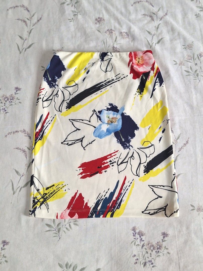 Abstract Floral Print Skirt (Category: Scarves) located in Taguig. Submitted by butterflypea.thrift (Listing ID 1461063193, Image 1). Description: - Cream-colored skiry - Vibrant abstract floral print - Features bold splashes of red, yellow, and navy blue - Includes black line art flowers - Perfect for adding a pop of color to any outfit.