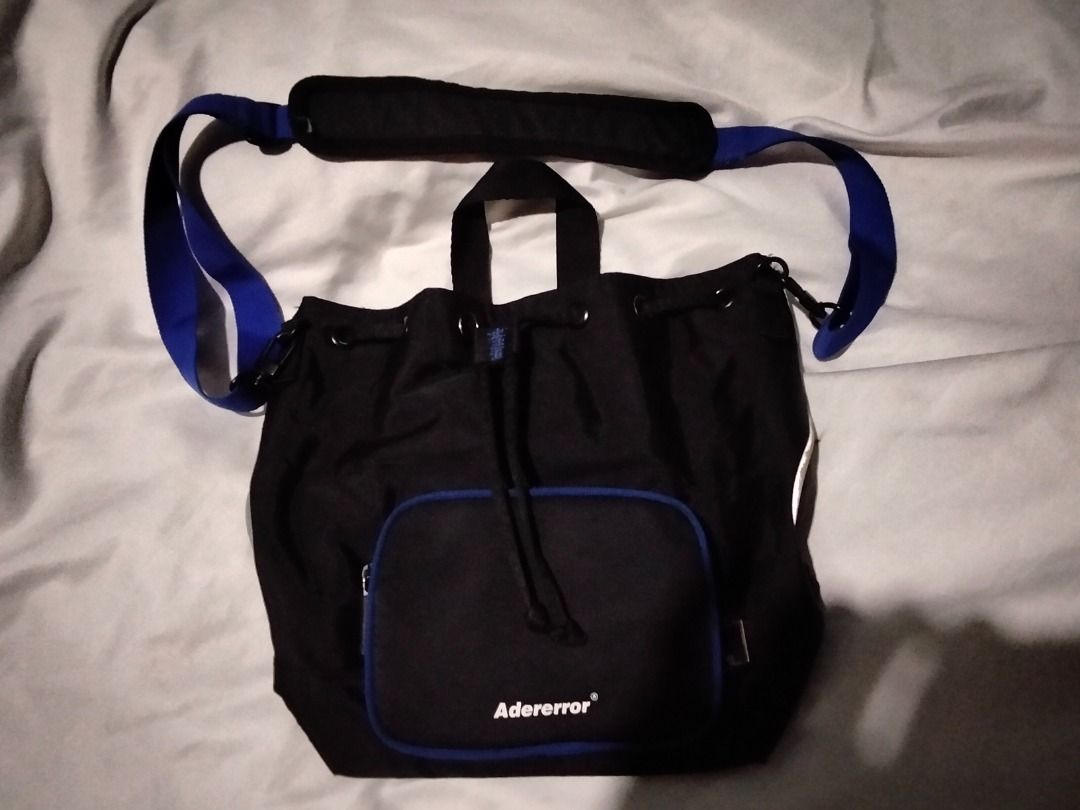ADER error Black Nylon Drawstring Bucket Bag (Category: Luxury Bags & Wallets) located in Malay. Submitted by junelformentera (Listing ID 1461009017, Image 3). Description: - Authentic ADER error bucket bag - Made in Korea - Material: Nylon with Polyester lining - Features: Front zip pocket with blue trim, drawstring closure, internal magnetic snap closure - Season: 2019 Spring Summer - Product Code: 19ASSBA02BK3 w/ minimal issue see photos.