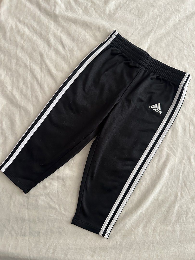 Adidas Black Track Pants with White Stripes (Category: Babies & Kids Fashion) located in Quezon City. Submitted by crslph (Listing ID 1460965675, Image 1). Description: - Classic black Adidas track pants - Iconic white three stripes on sides - Comfortable elastic waistband - Versatile for sports or casual wear - Easy to pair with any outfit -Tag size removed -Size: 18m.