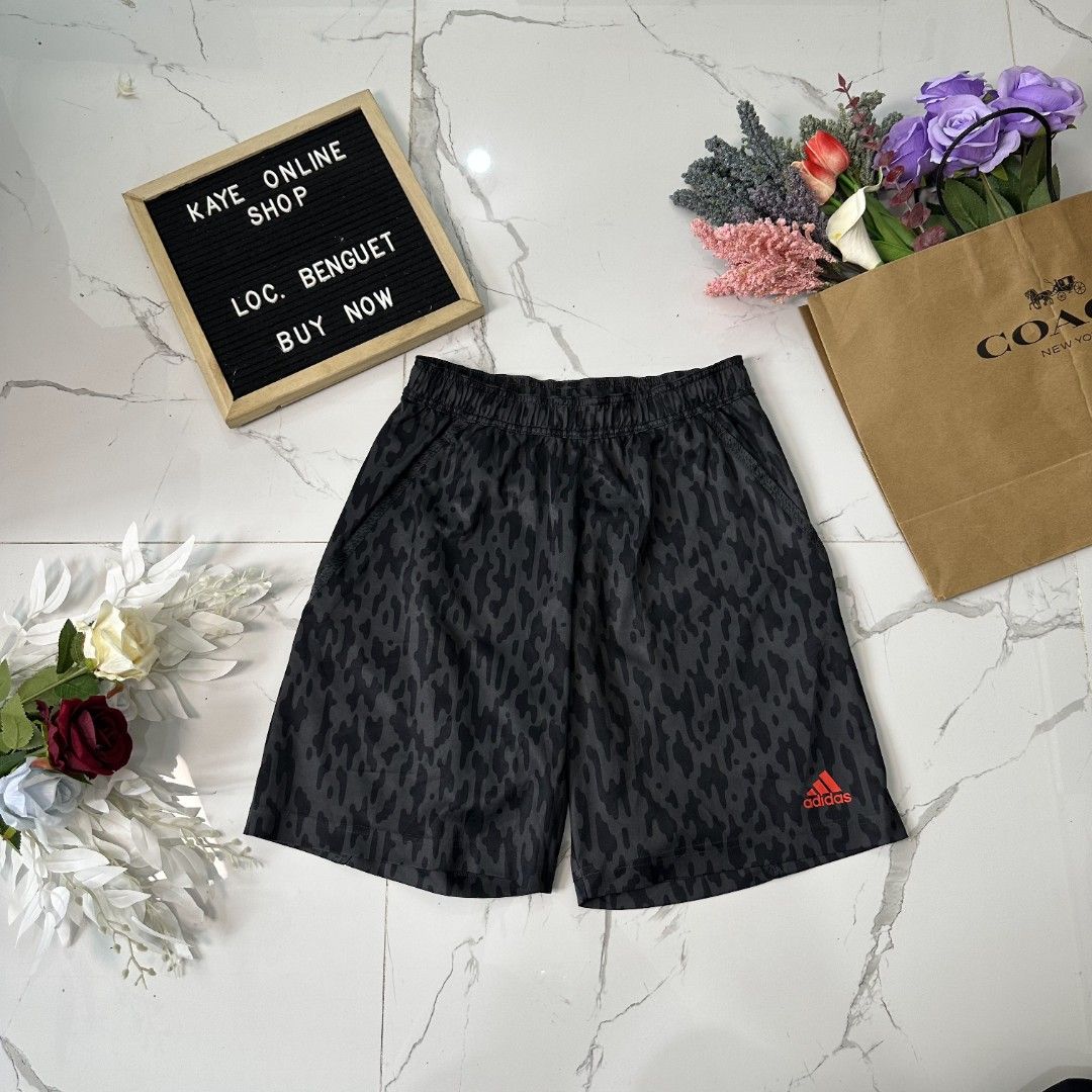 Adidas climalite Shorts (Category: Shorts) located in Baguio. Submitted by kayeonlineshop (Listing ID 1461005159, Image 2). Description: black athletic shorts featuring an abstract animal or camouflage-style print with a red Adidas logo on the lower leg. l18 w26-36 h23.