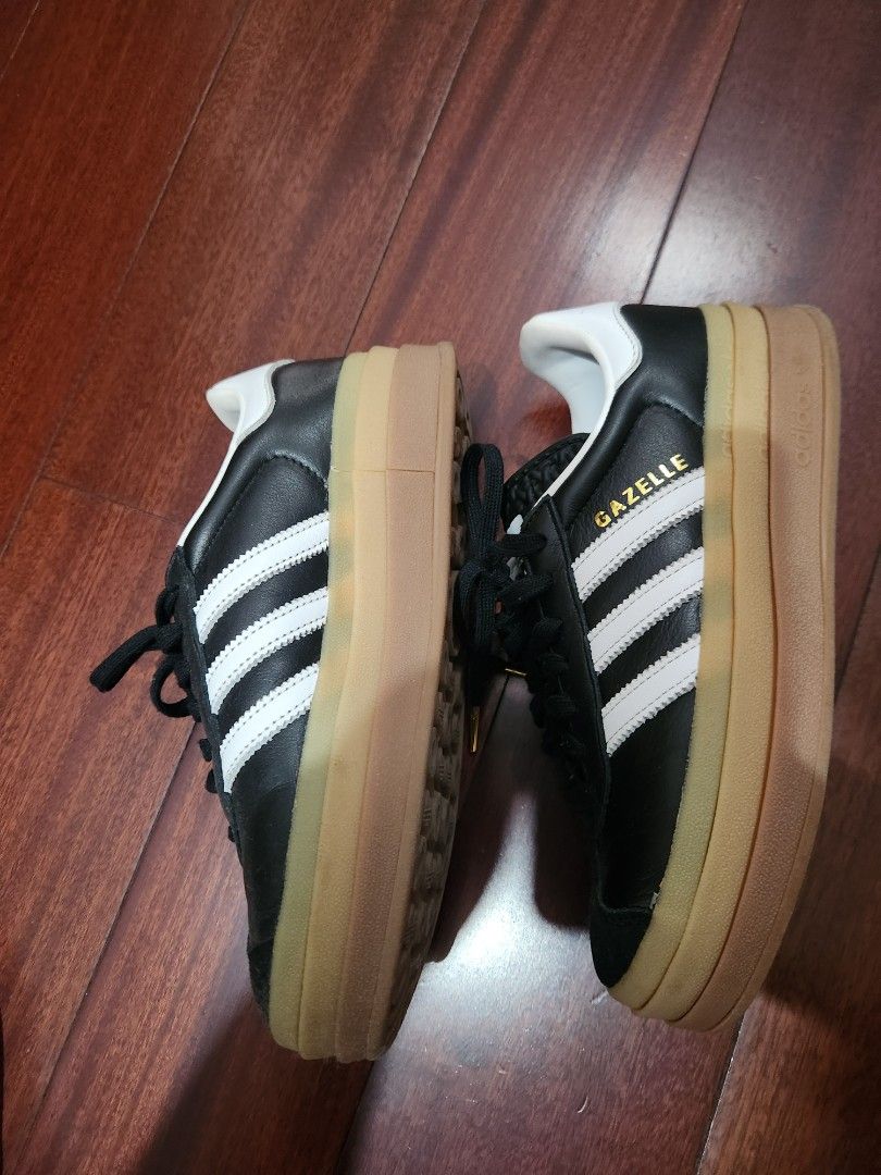 Adidas Gazelle Platform Sneakers (Category: Sneakers) located in Makati City. Submitted by mikamix (Listing ID 1460977615, Image 2). Description: - Black Adidas Gazelle platform sneakers - Features iconic white stripes - Classic gum sole - Lace-up closure with stylish gold tips - Platform sole for added height - Perfect for everyday casual wear - Shows some signs of wear on the leather and sole size US 6.5 no box.