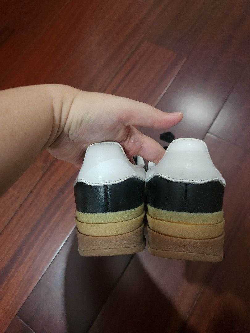 Adidas Gazelle Platform Sneakers (Category: Sneakers) located in Makati City. Submitted by mikamix (Listing ID 1460977615, Image 3). Description: - Black Adidas Gazelle platform sneakers - Features iconic white stripes - Classic gum sole - Lace-up closure with stylish gold tips - Platform sole for added height - Perfect for everyday casual wear - Shows some signs of wear on the leather and sole size US 6.5 no box.