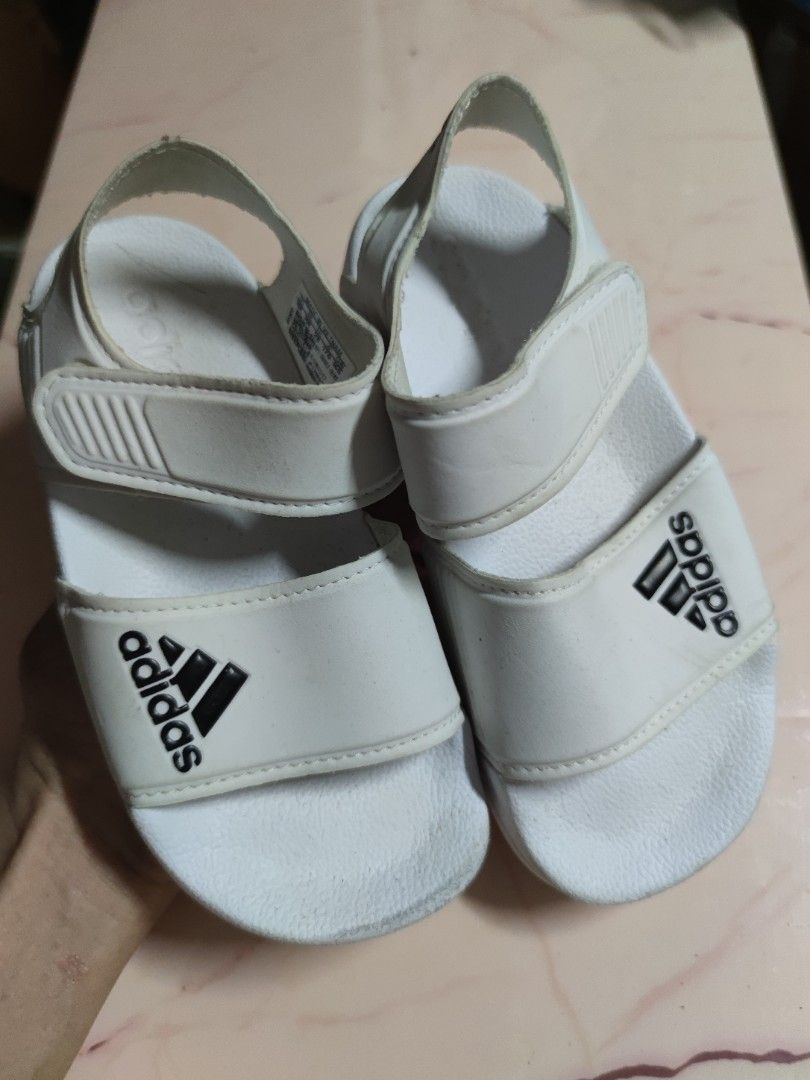 Adidas Kids White Velcro Strap Sandals (Category: Babies & Kids Fashion) located in Dagupan City. Submitted by jhazrightshop (Listing ID 1461009032, Image 1). Description: - White Adidas Kids Sandals - Size: 10K - Features easy-to-adjust Velcro straps - Made in Vietnam - Shows minor scuffs from normal wear, but still has plenty of life left.