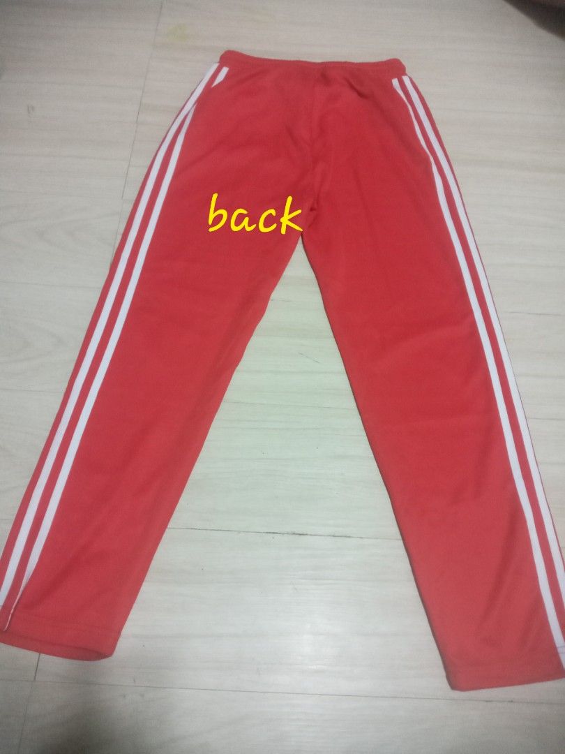 Adidas Red Track Pants Size L (Category: Joggers) located in San Rafael. Submitted by coolflower.462701 (Listing ID 1461049389, Image 2). Description: - Red Adidas track pants - White stripes on the sides - Size: Large (L) - Features a drawstring waist - Ideal for sports or casual wear.
