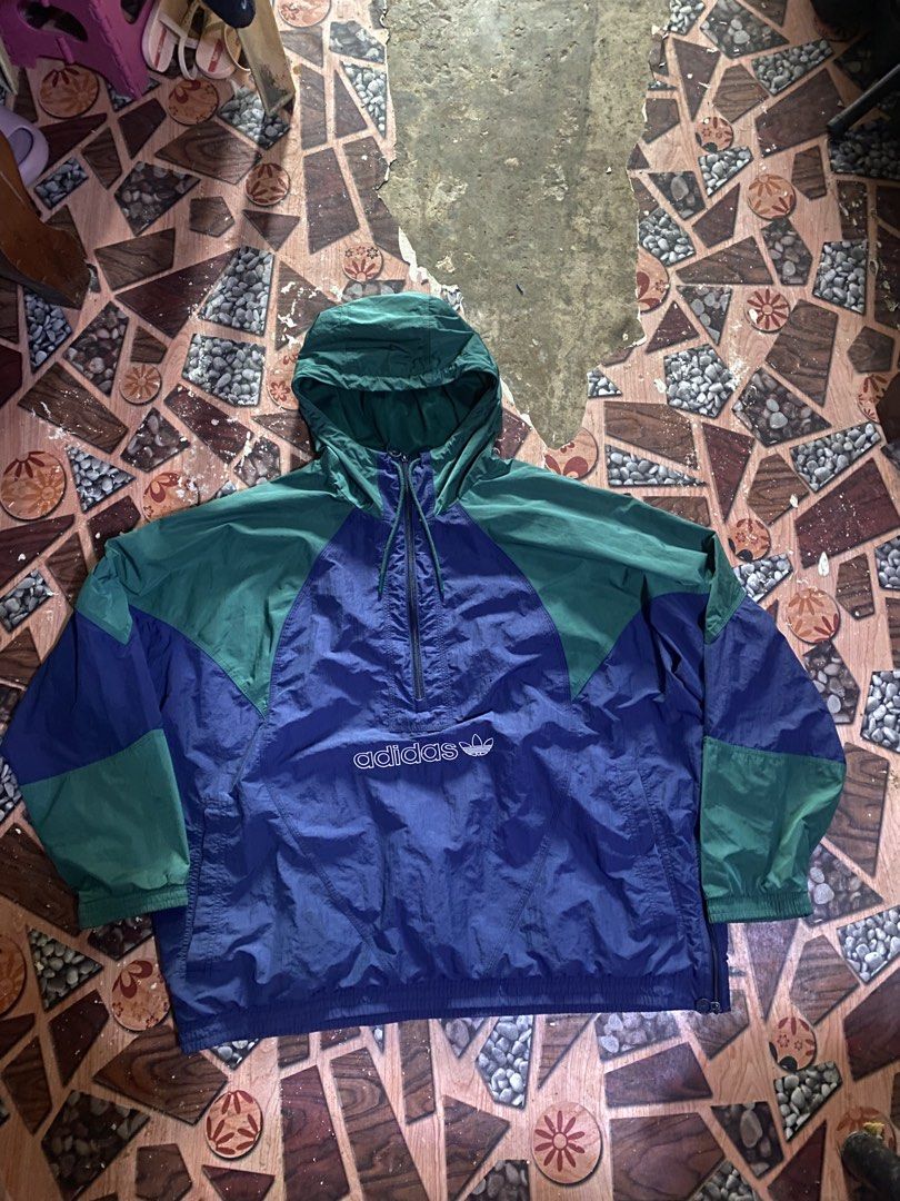 Adidas Windbreaker Anorak Jacket Blue Green (Category: Coats, Jackets and Outerwear) located in Manila. Submitted by kentmarion.water (Listing ID 1460936434, Image 1). Description: - Vintage Adidas anorak jacket - Colorblocked in blue and green - Classic trefoil logo on back and chest - Half-zip closure with hood - Made in Vietnam - Great piece for collectors!.