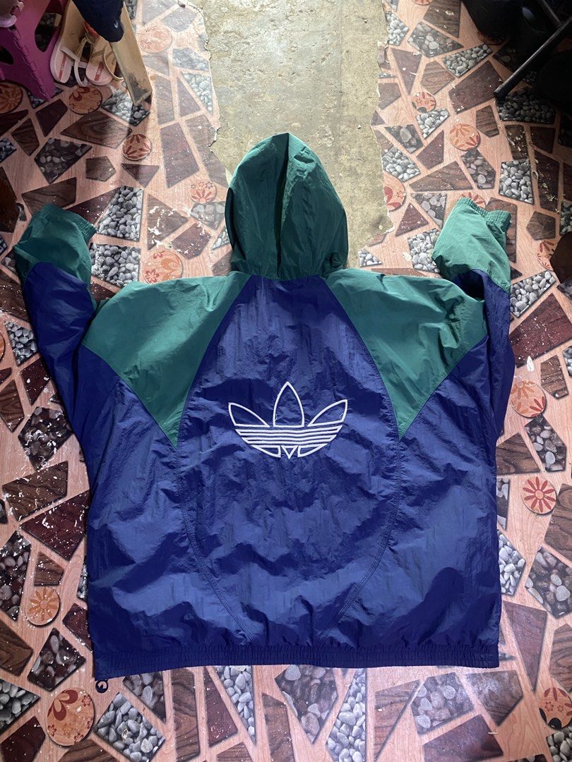 Adidas Windbreaker Anorak Jacket Blue Green (Category: Coats, Jackets and Outerwear) located in Manila. Submitted by kentmarion.water (Listing ID 1460936434, Image 2). Description: - Vintage Adidas anorak jacket - Colorblocked in blue and green - Classic trefoil logo on back and chest - Half-zip closure with hood - Made in Vietnam - Great piece for collectors!.