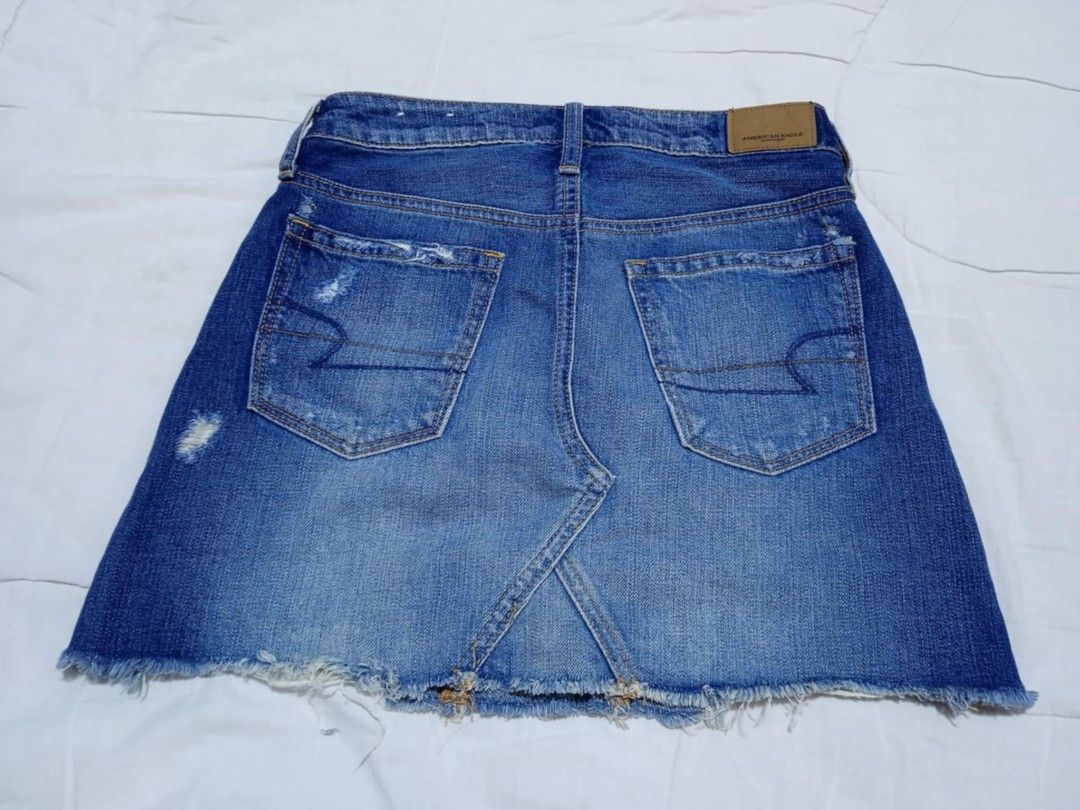 American Eagle Denim Mini Skirt (Category: Skirts) located in Manila. Submitted by dear__riri__ (Listing ID 1460976235, Image 2). Description: - American Eagle blue denim mini skirt - Features rips and distressed details - Raw hemline - Classic 5-pocket styling - Ideal for casual wear.