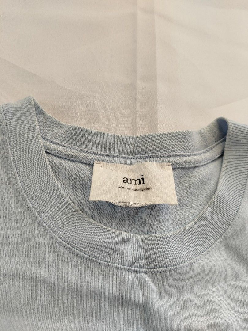 AMI big logo tee (Category: Luxury Apparel) located in Bocaue. Submitted by ukaynipepe (Listing ID 1460944387, Image 3). Description: Ami Baby blue (Searchable code) Small on tag Width 20.5 Length 27 Excellent condition Issue unnoticeable stain.