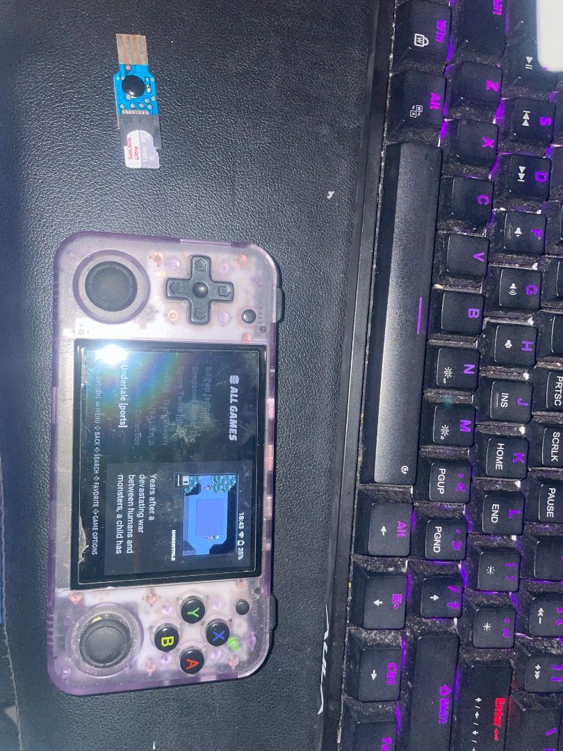 Anbernic RG 35XXH (Category: Cases & Sleeves) located in Caloocan City. Submitted by pure.kailix011523 (Listing ID 1461087580, Image 2). Description: - Brand: Anbernic - Model: RG35XXH - Type: Handheld Retro Gaming Console - Design: Transparent casing, allowing view of internal components - Included Accessories: USB adapter (SIM card slot visible ISSUE: Right Button 1 Cant be clicked Back Rubber is gone INCLUSIONS 32GB SD CARD (Knulli OS) 128GB S