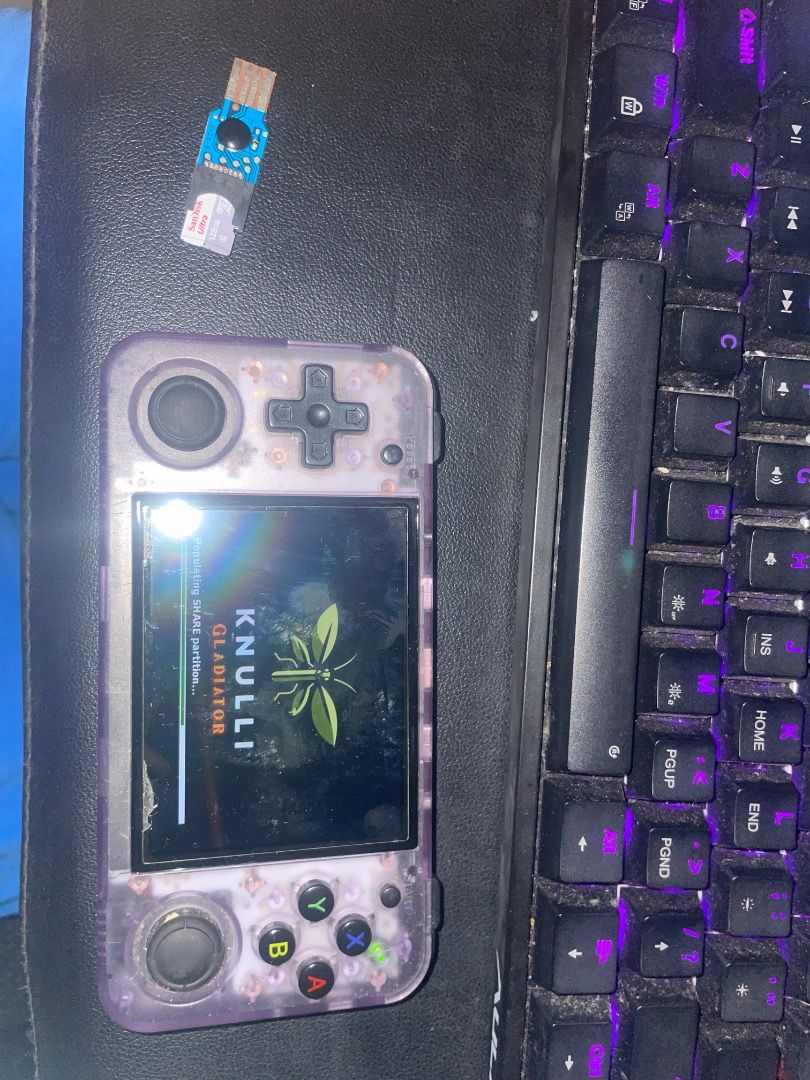 Anbernic RG 35XXH (Category: Cases & Sleeves) located in Caloocan City. Submitted by pure.kailix011523 (Listing ID 1461087580, Image 1). Description: - Brand: Anbernic - Model: RG35XXH - Type: Handheld Retro Gaming Console - Design: Transparent casing, allowing view of internal components - Included Accessories: USB adapter (SIM card slot visible ISSUE: Right Button 1 Cant be clicked Back Rubber is gone INCLUSIONS 32GB SD CARD (Knulli OS) 128GB S