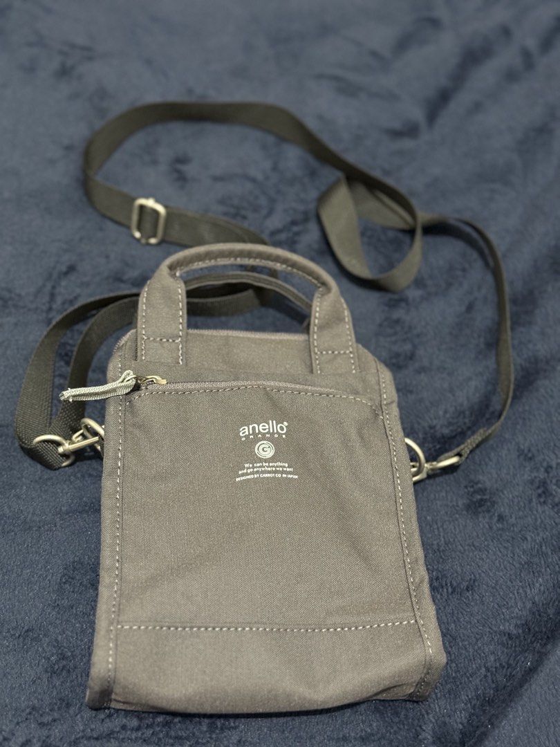 Anello Canvas Crossbody Bag Dark Grey (Category: Cross-body Bags) located in Batangas. Submitted by cathevans (Listing ID 1460977467, Image 1). Description: - Anello crossbody bag in dark grey canvas - Main zippered compartment with inner pockets - Front zippered pocket for quick access - Two top handles for versatile carrying - Adjustable shoulder strap for comfort - Ideal for everyday use and carrying essentials.