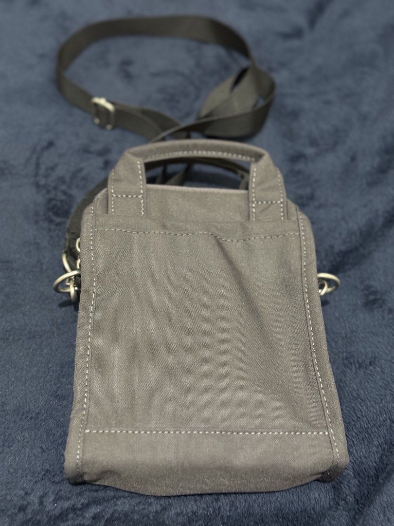Anello Canvas Crossbody Bag Dark Grey (Category: Cross-body Bags) located in Batangas. Submitted by cathevans (Listing ID 1460977467, Image 2). Description: - Anello crossbody bag in dark grey canvas - Main zippered compartment with inner pockets - Front zippered pocket for quick access - Two top handles for versatile carrying - Adjustable shoulder strap for comfort - Ideal for everyday use and carrying essentials.