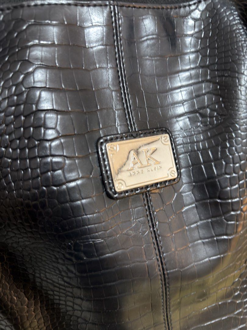 Anne Klein Black Croc Embossed Tote Bag (Category: Tote Bags) located in Cavite. Submitted by misyelandco (Listing ID 1461107917, Image 2). Description: - Brand: Anne Klein - can fit (laptop) - Color: Black - Material: Croc-embossed faux leather - Main compartment: Zippered with interior zip pocket - Exterior pockets: Zip pockets and buckle flap pockets on sides - Handles: Top handles for carrying - Style: Great everyday bag.
