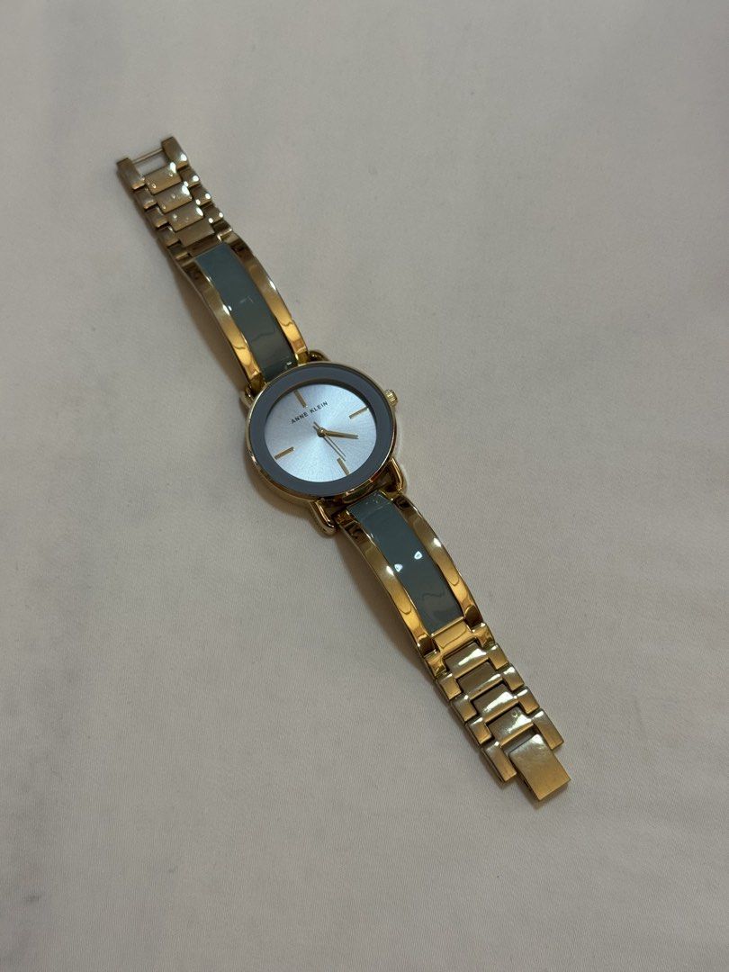 Anne Klein Gold and Blue Bangle Watch (Category: Women's Watches) located in Manila. Submitted by khatalogue (Listing ID 1460990382, Image 3). Description: - Anne Klein watch - Gold tone with blue accents - Light blue watch face with gold hands and markers - Stainless steel back - Mixed gold and blue segment band - Looks great on the wrist - Perfect accessory - Adjustable .