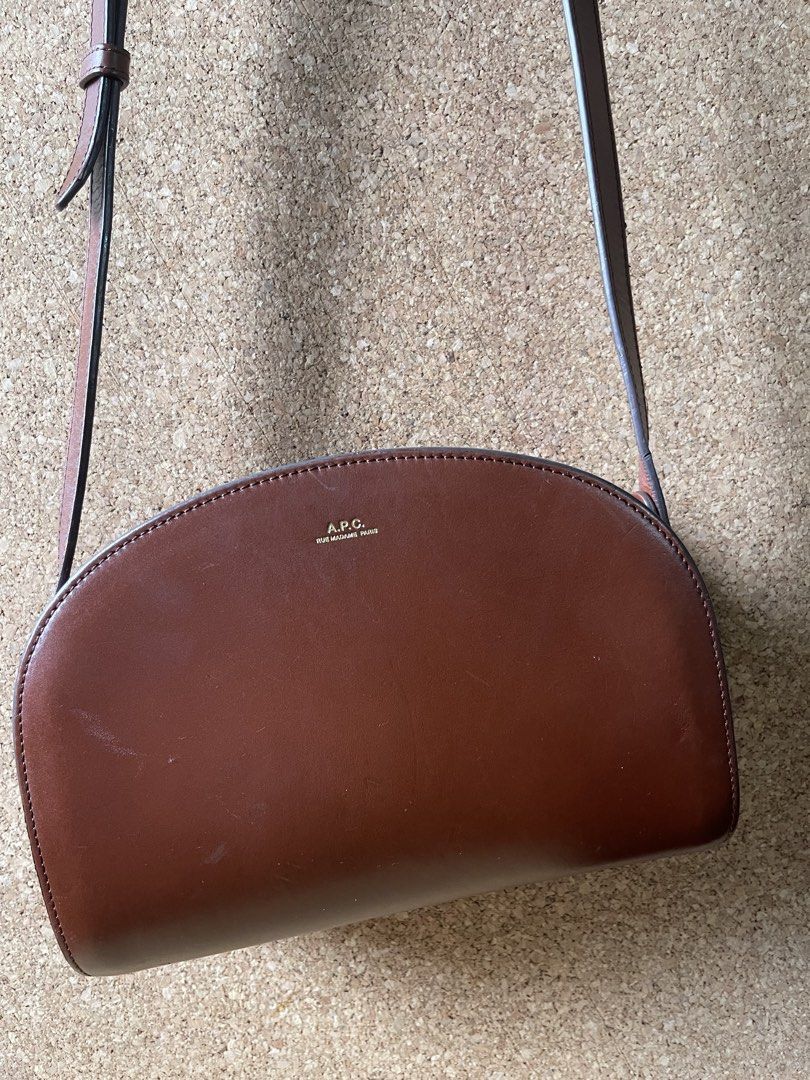 A.P.C. Demi-Lune Bag Brown Leather (Category: Luxury Bags & Wallets) located in Pasig City. Submitted by 3toddlers (Listing ID 1461113565, Image 2). Description: Letting go of my pre-loved bags I bought this at the store, authentic APC - Classic A.P.C. Demi-Lune bag - Material: Rich brown leather - Closure: Zip - Strap: Adjustable shoulder strap - Design: Iconic half-moon shape - Includes: Original dust bag - Ideal for: Everyday use - minimal scr