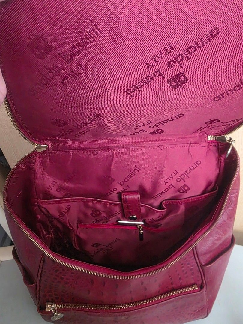 ARNALDO BASSINI ITALY BACKPACK (Category: Backpacks) located in Manila. Submitted by yammm23 (Listing ID 1460979840, Image 3). Description: ARNALDO BASSINI ITALY BACKPACK Stylish, elegant, and practical! ❤️ This maroon crocodile-textured backpack is perfect for everyday use, work, school, travel, or casual outings. ✨ Features: 👍Rich maroon/burgundy color 👍Elegant crocodile-embossed texture 👍Spacious main compartment 👍Multiple zippered pockets