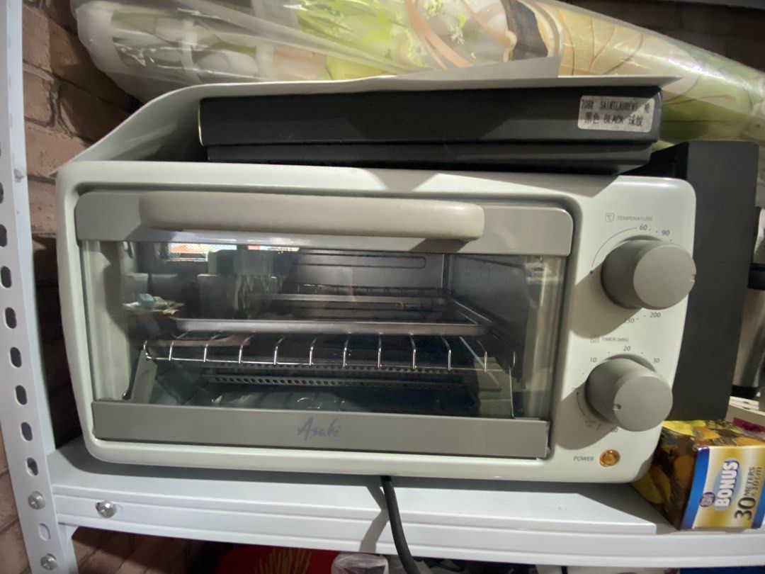Asahi OT-101 Oven Toaster (Category: Ovens & Toasters) located in Manila. Submitted by jellybbean (Listing ID 1461010127, Image 2). Description: - Asahi OT-101 Oven Toaster - Simple controls: two knobs for temperature and timer - Versatile: ideal for toasting bread, baking small items, and reheating food - Convenient: downward-opening door with baking tray and rack included - Compact: fits easily on kitchen countertops.