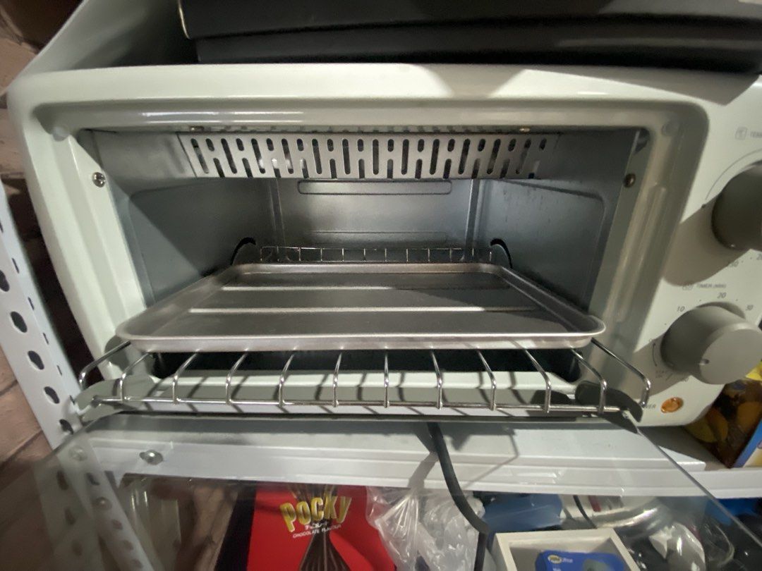 Asahi OT-101 Oven Toaster (Category: Ovens & Toasters) located in Manila. Submitted by jellybbean (Listing ID 1461010127, Image 3). Description: - Asahi OT-101 Oven Toaster - Simple controls: two knobs for temperature and timer - Versatile: ideal for toasting bread, baking small items, and reheating food - Convenient: downward-opening door with baking tray and rack included - Compact: fits easily on kitchen countertops.