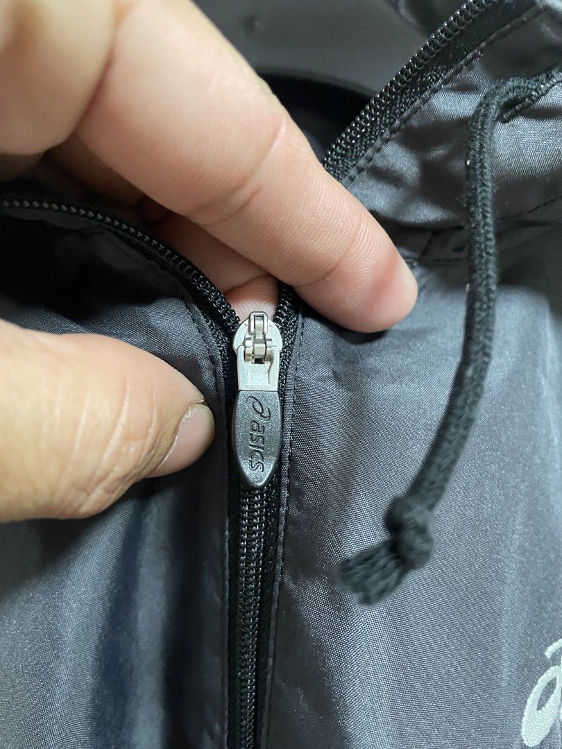 Asics Black Hooded Windbreaker Jacket (Category: Coats, Jackets and Outerwear) located in Lapu Lapu. Submitted by mackoy221524 (Listing ID 1461086737, Image 2). Description: - Black Asics windbreaker jacket - Size: Medium (M) - Features a hood - Half-zip closure - Material: 100% Polyester - Ideal for sports and casual wear - Please check photos for condition details.