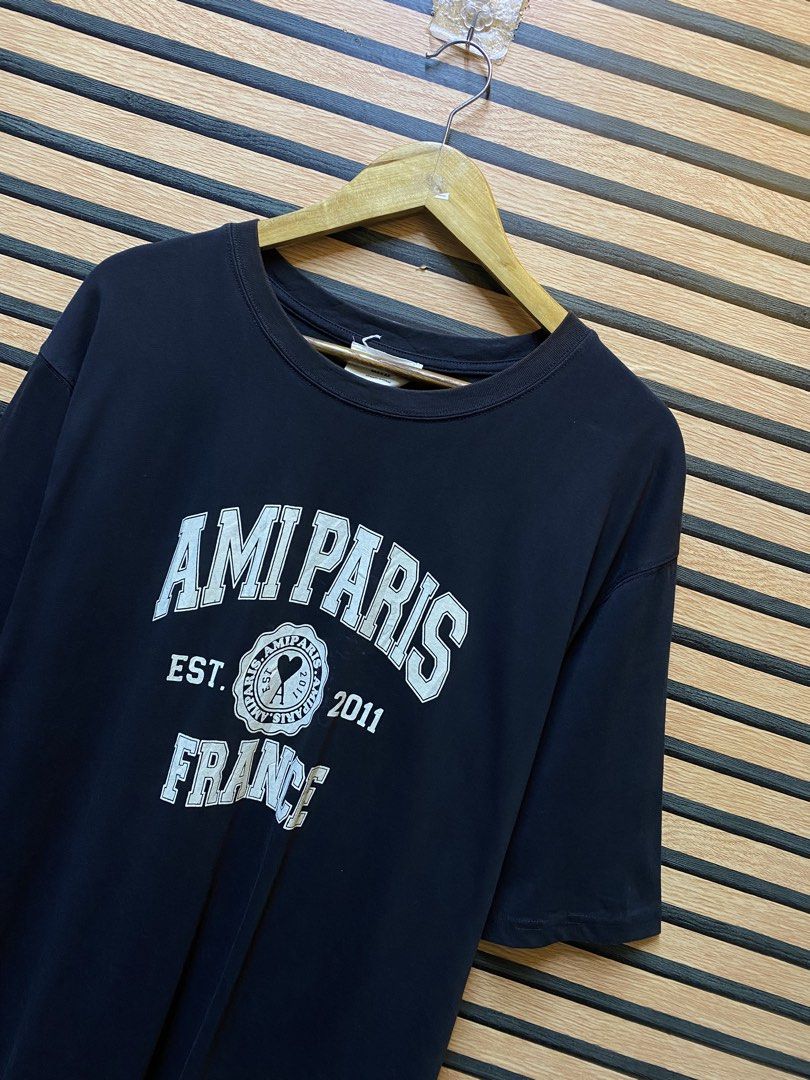 AUTHENTIC AMI PARIS “FRANCE” (Category: Tshirts & Polo Shirts ) located in Makati City. Submitted by drip.poww (Listing ID 1461100781, Image 2). Description: - Authentic Ami Paris - Color: Black - Size: Large - Dimes: 23x28 - Authentic - Excellent condition - Need wash, fresh from bale - Material: 100% Cotton Please don’t expect too much—these are thrifted (ukay) items. 😊 !!STILL NEGOTIABLE!!.