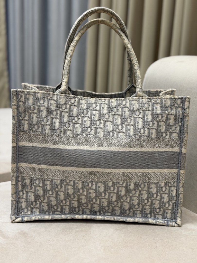 Authentic Christian Dior Medium Booktote (Category: Luxury Bags & Wallets) located in Manila. Submitted by maria_2326 (Listing ID 1461029128, Image 2). Description: Christian Dior Medium Booktote Ecru and Gray Oblique canvas Guarantee Authentic W/ dust bag only No lowballing! Location: Manila/QC.