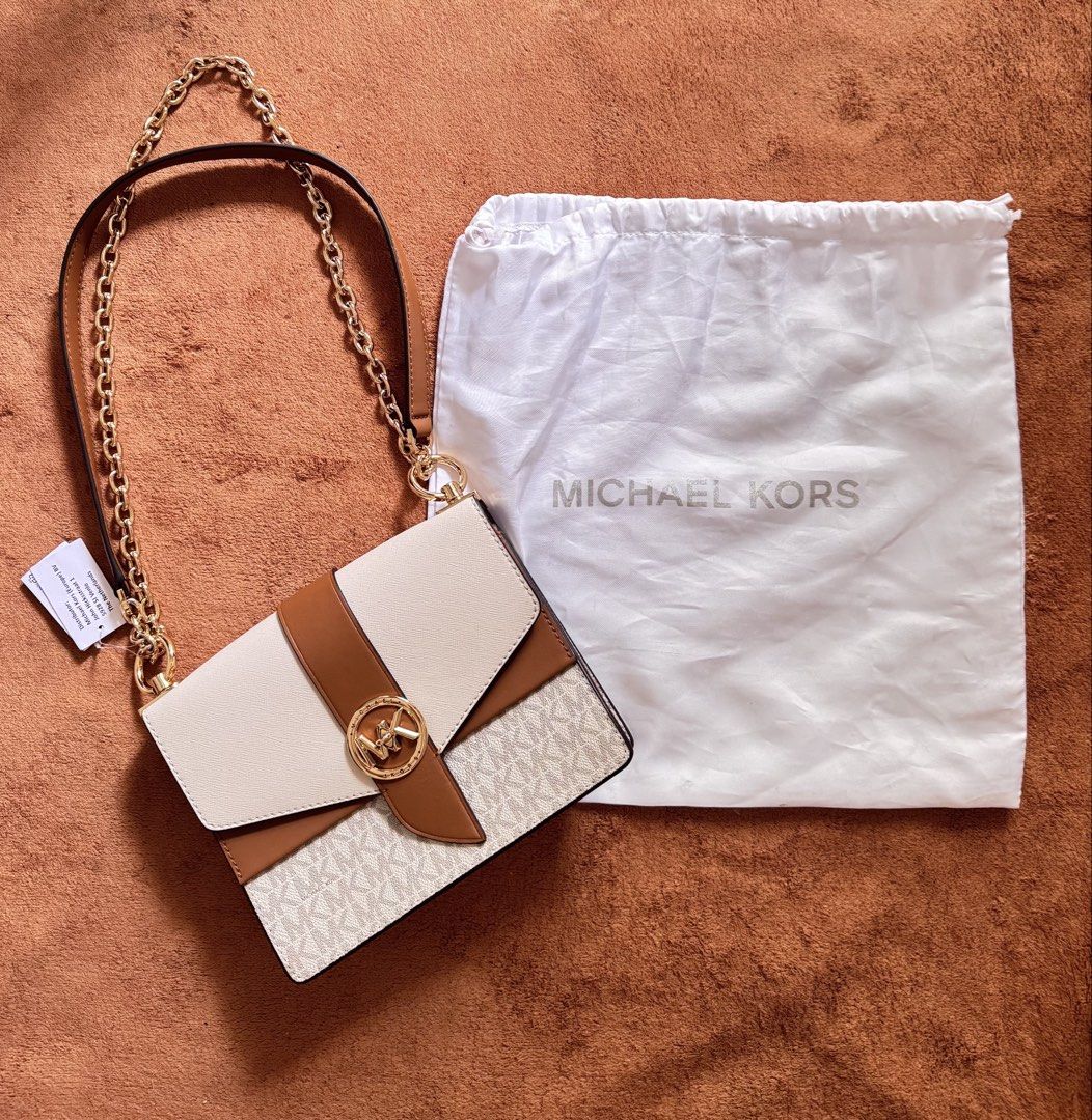 Authentic Michael Kors Greenwich Crossbody Bag (Category: Cross-body Bags) located in Pasig City. Submitted by ronabels01 (Listing ID 1461068067, Image 2). Description: Authentic bought in Milan, Italy Details: * Style: Empire Medium Chain-Link Pochette * Color: Vanilla/Luggage (cream + brown) * Material: Signature coated canvas + leather trim * Hardware: Gold-tone * Closure: Magnetic/turn-lock flap * Strap: Adjustable leather + gold chain * Size