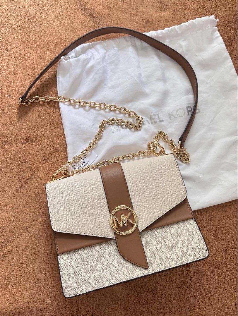 Authentic Michael Kors Greenwich Crossbody Bag (Category: Cross-body Bags) located in Pasig City. Submitted by ronabels01 (Listing ID 1461068067, Image 1). Description: Authentic bought in Milan, Italy Details: * Style: Empire Medium Chain-Link Pochette * Color: Vanilla/Luggage (cream + brown) * Material: Signature coated canvas + leather trim * Hardware: Gold-tone * Closure: Magnetic/turn-lock flap * Strap: Adjustable leather + gold chain * Size