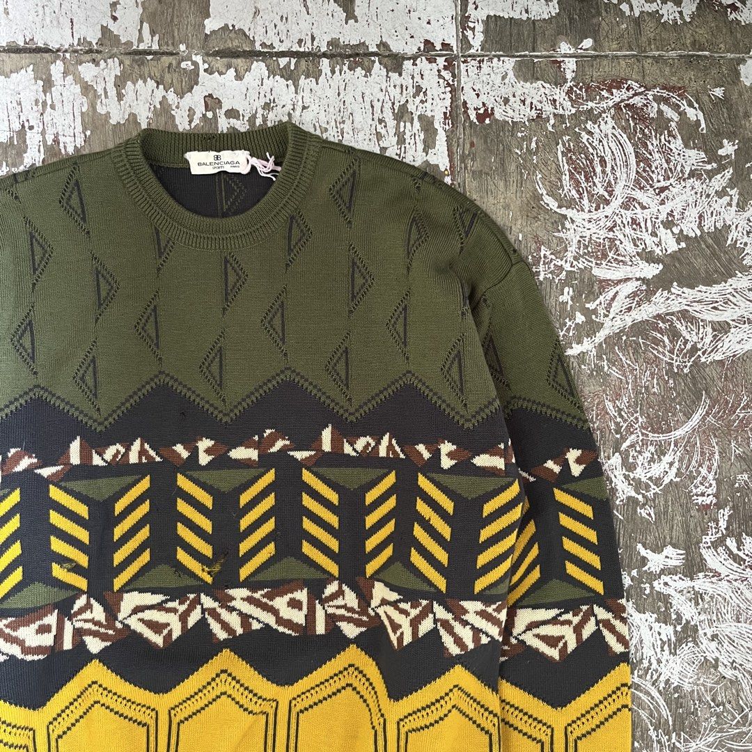 BALENCIAGA 80S KNITTED LS (Category: Hoodies) located in Iloilo. Submitted by plugsta (Listing ID 1461012180, Image 2). Description: olive green knit sweater with a geometric triangle pattern and a Balenciaga Sports label. MEASUREMENT: 21W/26L 22 IN SLEEVE LENGTH DETAILS POSTED .