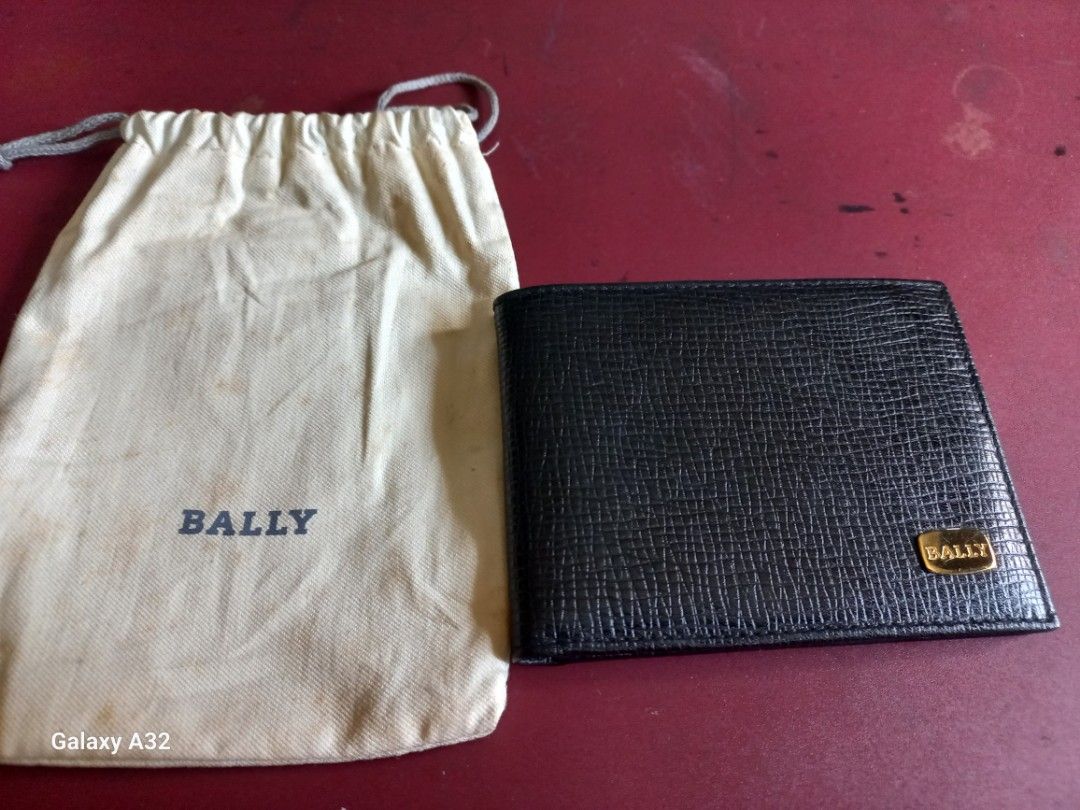 Bally Black Leather Bi-fold Wallet with Gold Emblem (Category: Luxury Bags & Wallets) located in Quezon City. Submitted by isabelllv (Listing ID 1461082621, Image 2). Description: - Classic black leather bi-fold wallet by Bally. - Features the iconic gold Bally emblem on the front. - Comes with its original dust bag for protection. - Simple and highly functional design. - Ideal for everyday carry and use..