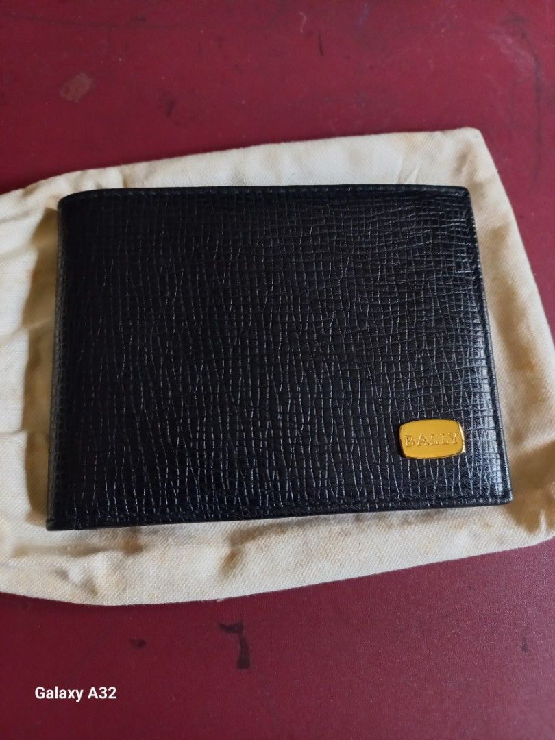 Bally Black Leather Bi-fold Wallet with Gold Emblem (Category: Luxury Bags & Wallets) located in Quezon City. Submitted by isabelllv (Listing ID 1461082621, Image 1). Description: - Classic black leather bi-fold wallet by Bally. - Features the iconic gold Bally emblem on the front. - Comes with its original dust bag for protection. - Simple and highly functional design. - Ideal for everyday carry and use..