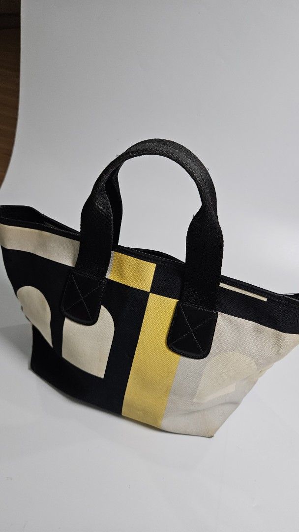 Bally leather Tote Bag (Category: Tote Bags) located in Alfonso. Submitted by jbcamet (Listing ID 1461033524, Image 2). Description: - Cool geometric print tote bag - Colors: Cream, yellow, and black - Black handles - Durable canvas-like material - Ideal size for everyday use - Perfect for carrying your essentials - Simple and stylish design.