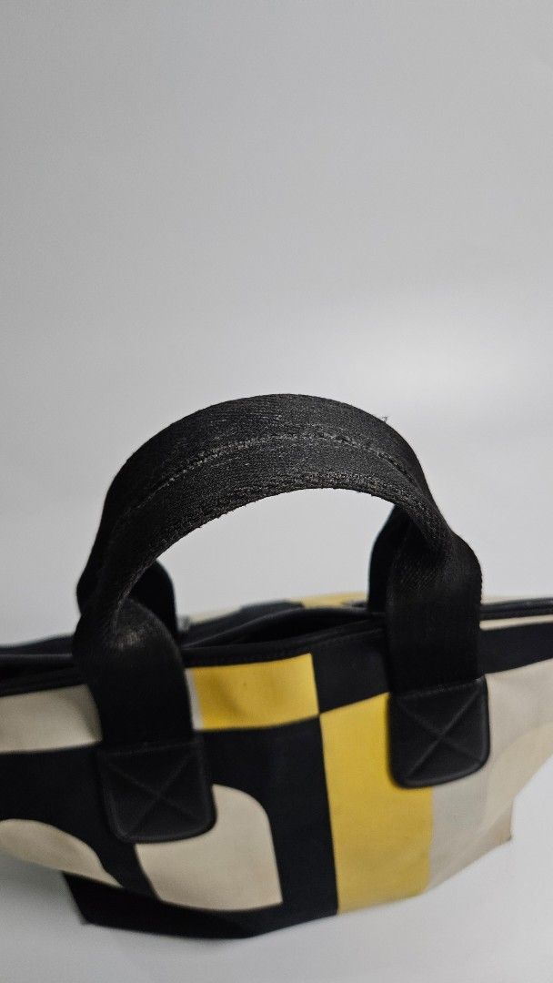 Bally leather Tote Bag (Category: Tote Bags) located in Alfonso. Submitted by jbcamet (Listing ID 1461033524, Image 3). Description: - Cool geometric print tote bag - Colors: Cream, yellow, and black - Black handles - Durable canvas-like material - Ideal size for everyday use - Perfect for carrying your essentials - Simple and stylish design.