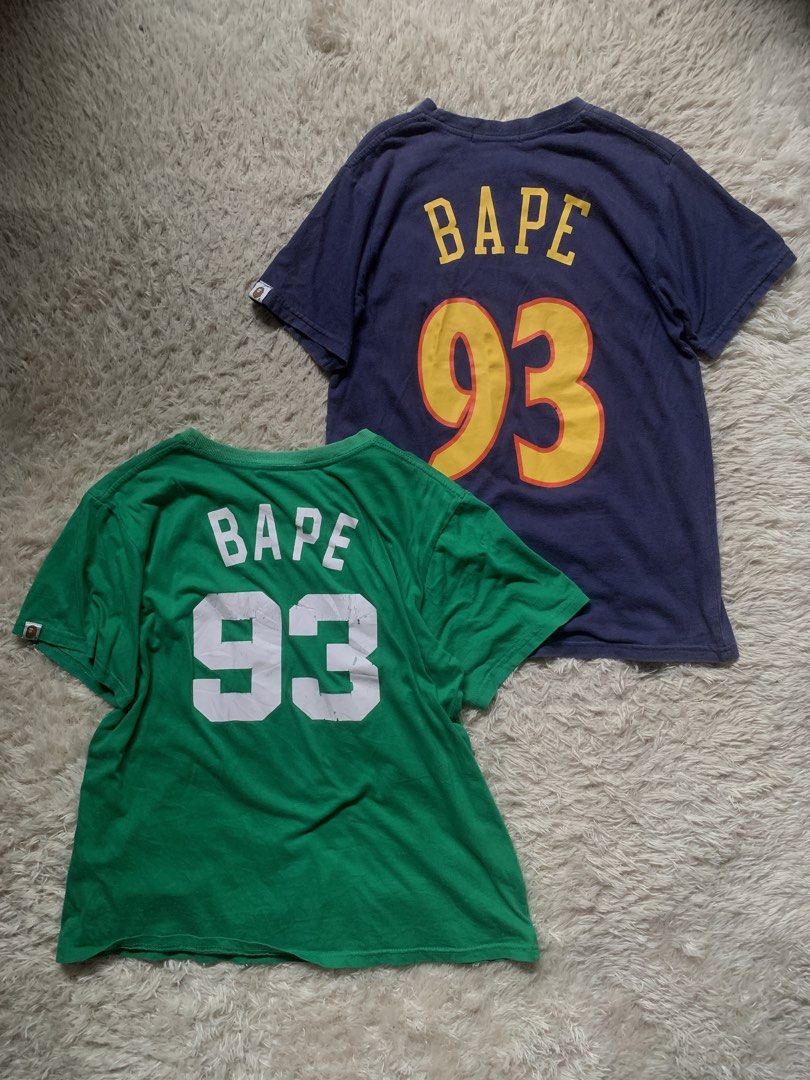 BAPE x NBA T-Shirts (Warriors & Celtics) (Category: Tshirts & Polo Shirts ) located in General Santos City (Dadiangas). Submitted by thrifty_gsc (Listing ID 1461023067, Image 2). Description: - BAPE T-Shirt Bundle: Navy Blue & Green - Navy Blue: Features Warriors logo & BAPE ape head - Green: Features Celtics logo & BAPE ape head - Both shirts have 'BAPE 93' printed on the back - Ideal for BAPE collectors and NBA enthusiasts - Unique and stylish 