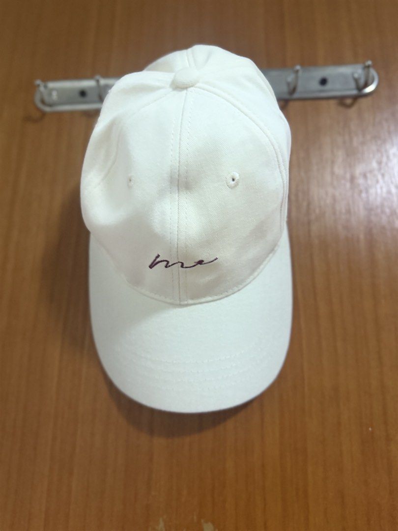 Baseball cap (Category: Hats & Beanies) located in Singapore. Submitted by florastudio (Listing ID 1461081421, Image 1). Description: - Classic white baseball cap - Features a subtle embroidered 'me' design - Versatile for everyday wear - Comfortable material.