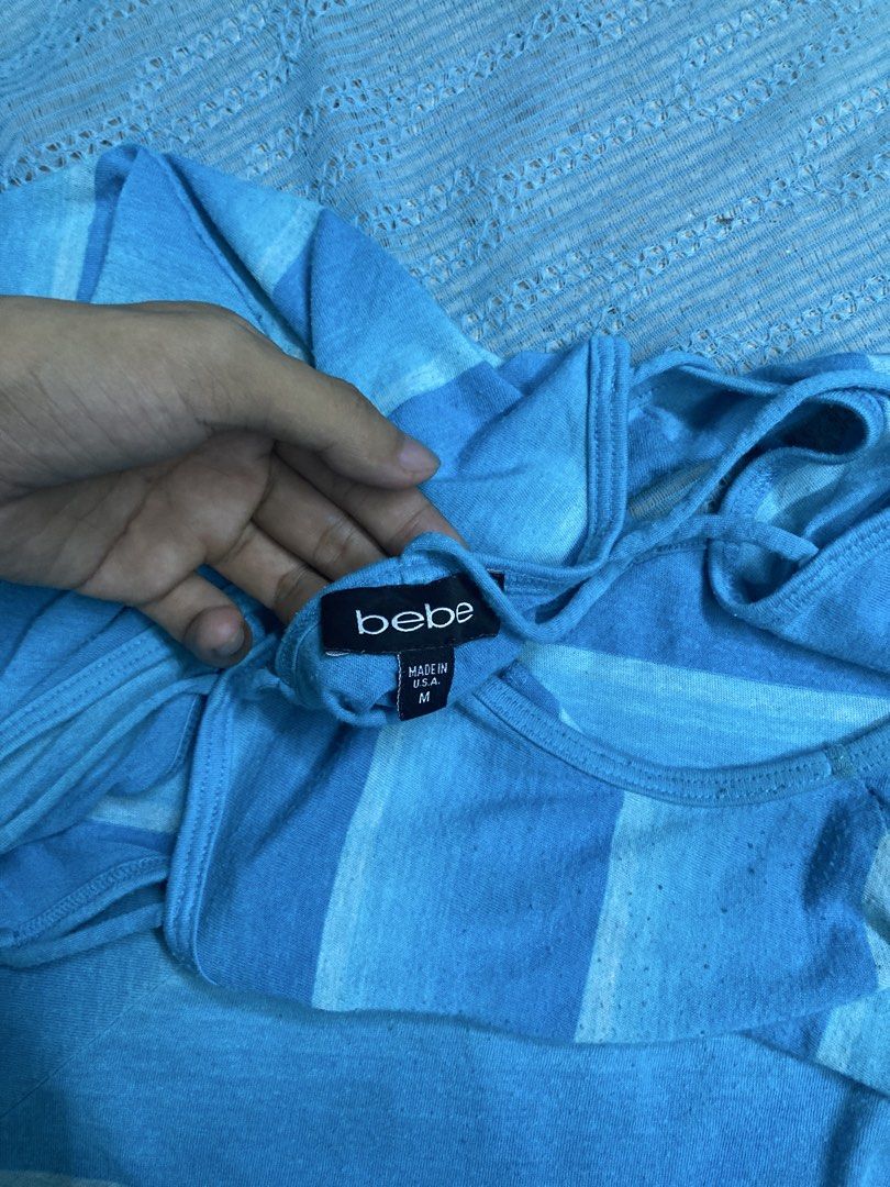 Bebe Blue Chevron Print Tank Top Size M (Category: Sleeveless) located in Manila. Submitted by vallestagr33229 (Listing ID 1461063350, Image 3). Description: - Cute Bebe tank top - Blue and white chevron print - Criss-cross detail on back - Bebe logo with rhinestones on front hem - Made in USA - Size M -Issue: stain.