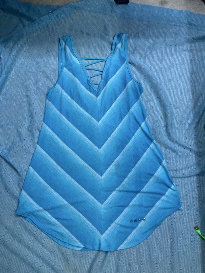 Bebe Blue Chevron Print Tank Top Size M (Category: Sleeveless) located in Manila. Submitted by vallestagr33229 (Listing ID 1461063350, Image 1). Description: - Cute Bebe tank top - Blue and white chevron print - Criss-cross detail on back - Bebe logo with rhinestones on front hem - Made in USA - Size M -Issue: stain.