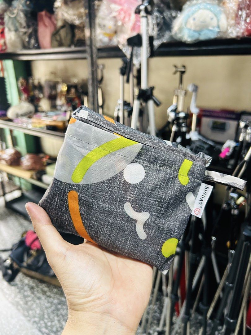 BIGHA'S Reusable Foldable Tote Bag (Category: Tote Bags) located in Manila. Submitted by starbalesukandjapansurplus (Listing ID 1460928806, Image 1). Description: - Cute and foldable tote bag from BIGHA'S - Ideal for groceries or everyday use - Folds up small to fit easily in your purse - Features a fun pattern with cartoon faces and colorful accents - Easy to carry and store.