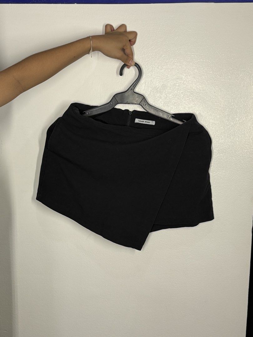 Black Asymmetrical Wrap Skort (Category: Shorts) located in Angeles City. Submitted by lesmiz24601 (Listing ID 1460965181, Image 1). Description: - Stylish black skort - Asymmetrical wrap front design - High-waisted for a flattering fit - Convenient back zipper closure - Skirt look with built-in shorts for comfort and practicality - 27-28” waistline - Ideal for dressing up or down.